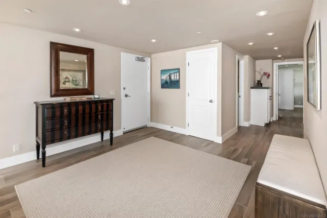 a spacious bedroom with a bed and a dresser