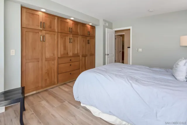 a bedroom with a wooden closet