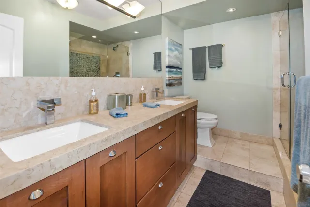 a bathroom with a sink a toilet and a mirror