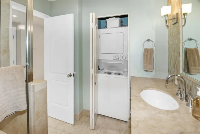 a bathroom with a sink vanity granite and a mirror