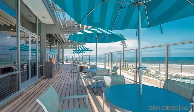 a roof deck with outdoor seating and city view