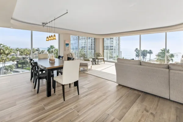 a dining room with furniture window and wooden floor