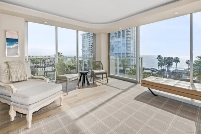 a living room filled with furniture and a large window