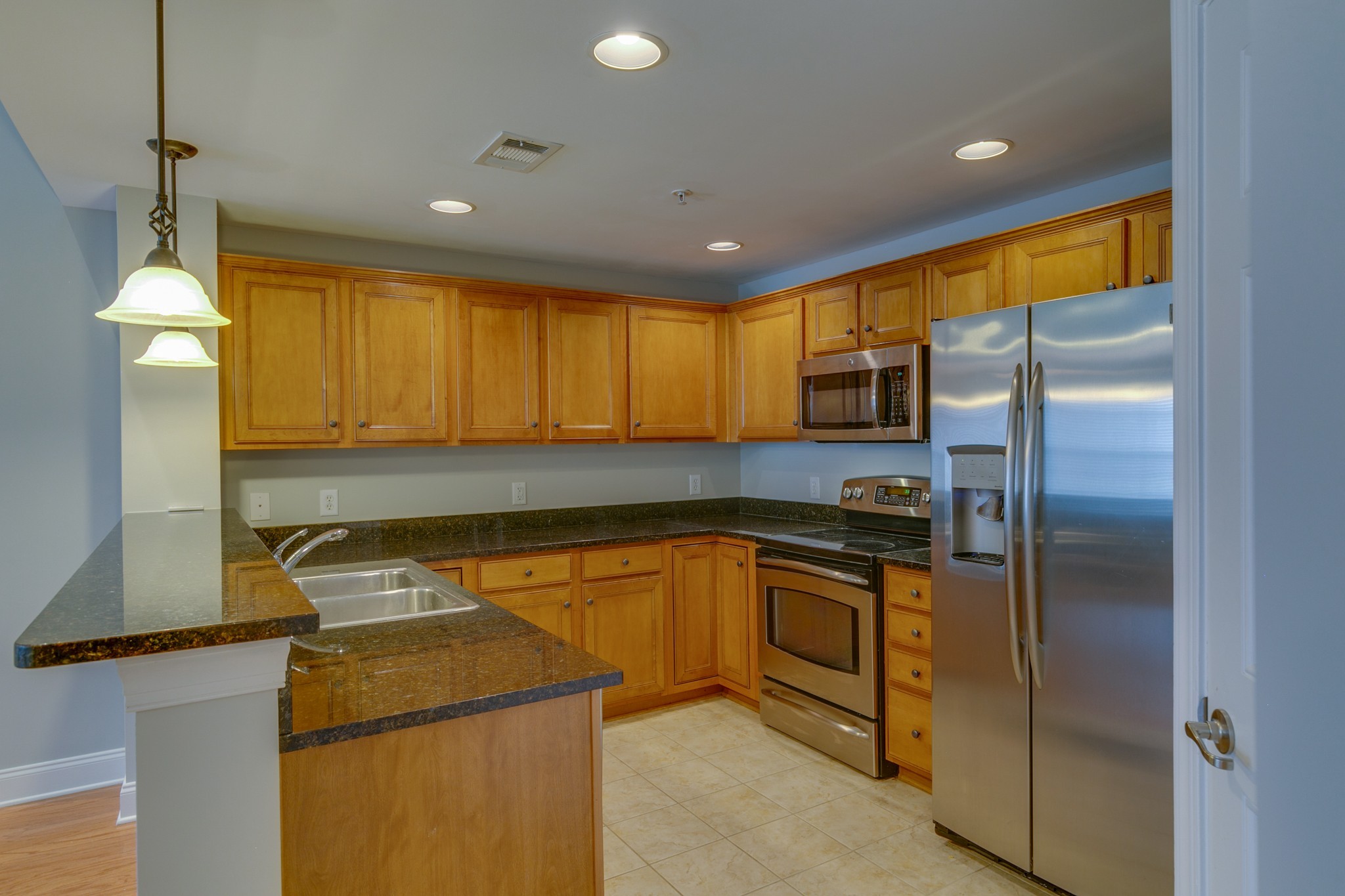 3201 Aspen Grove Drive, Unit B9 Franklin, TN 37067 - Photo 17 of 37 a kitchen with stainless steel appliances granite countertop a refrigerator a stove and a sink with wooden floor