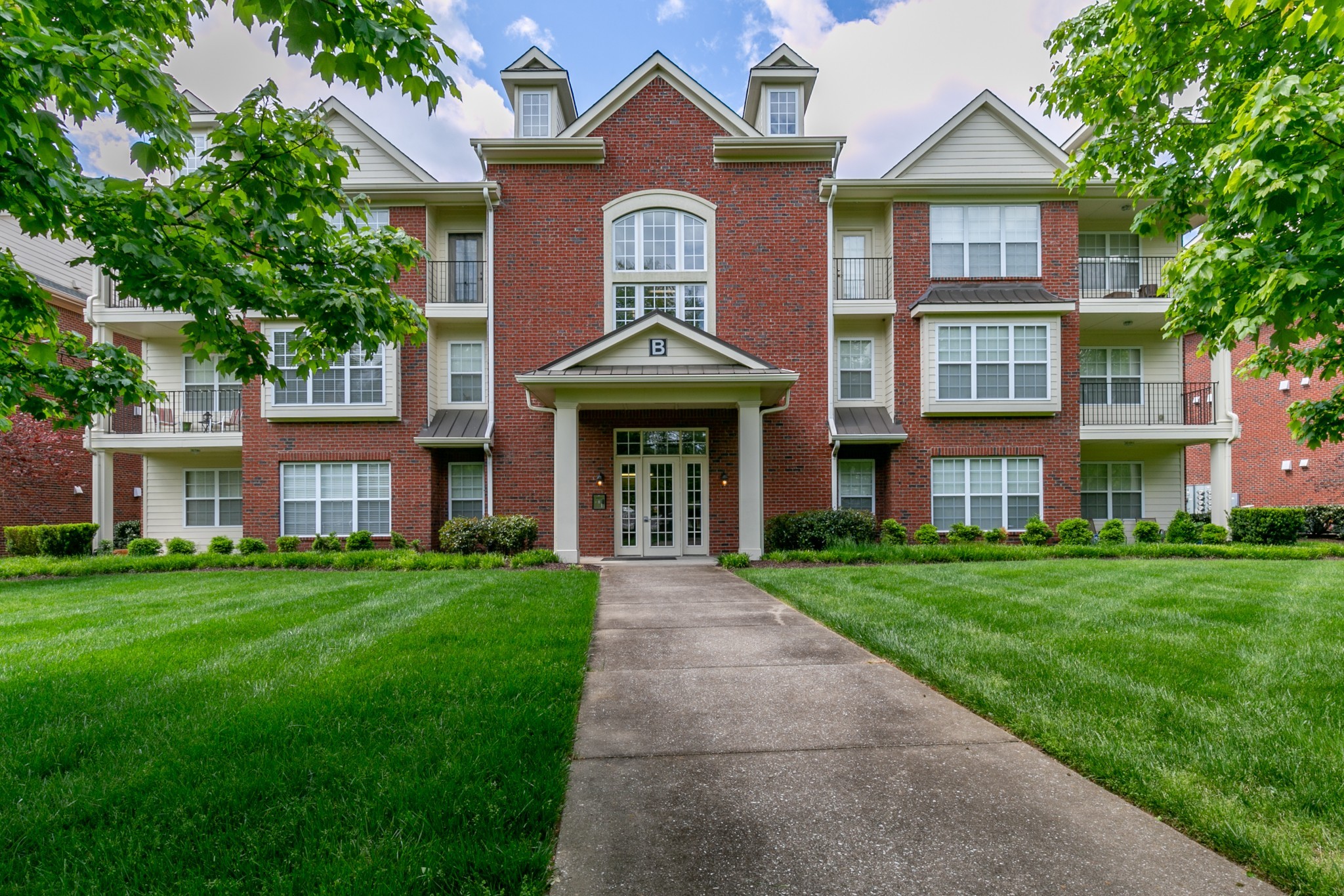 3201 Aspen Grove Drive, Unit B9 Franklin, TN 37067 - Photo 2 of 37 a front view of a house with a yard