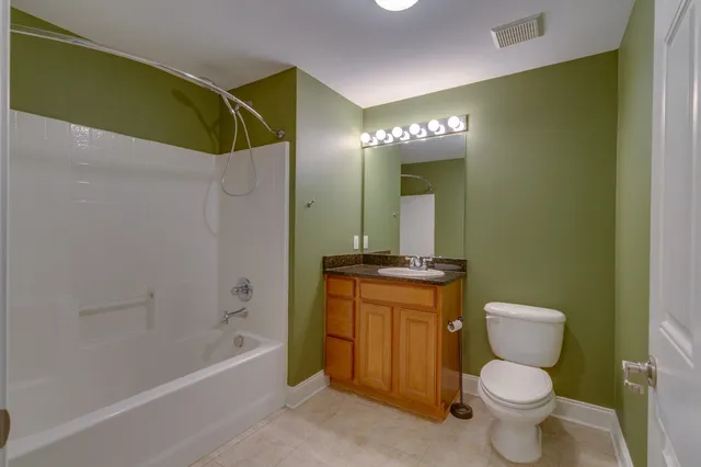 a bathroom with a toilet sink and shower