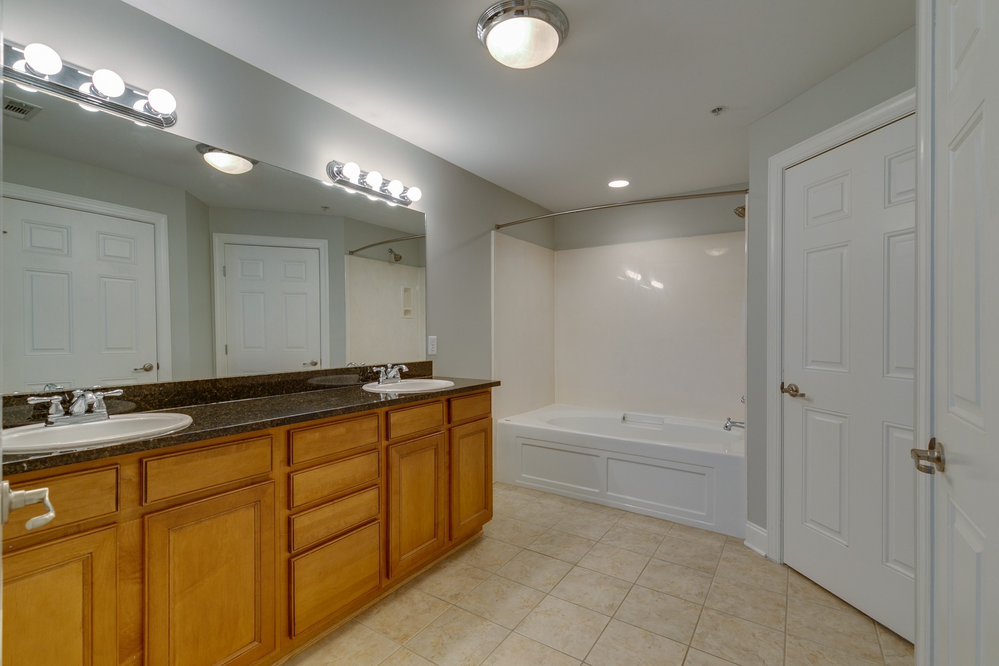3201 Aspen Grove Drive, Unit B9 Franklin, TN 37067 - Photo 28 of 37 a bathroom with a sink a large mirror and a bathtub