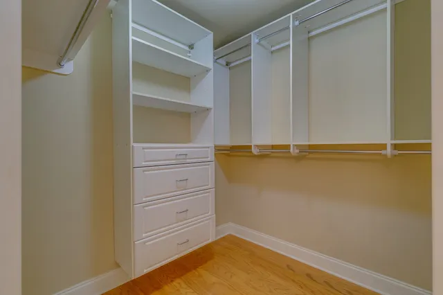 a view of walk in closet with empty racks
