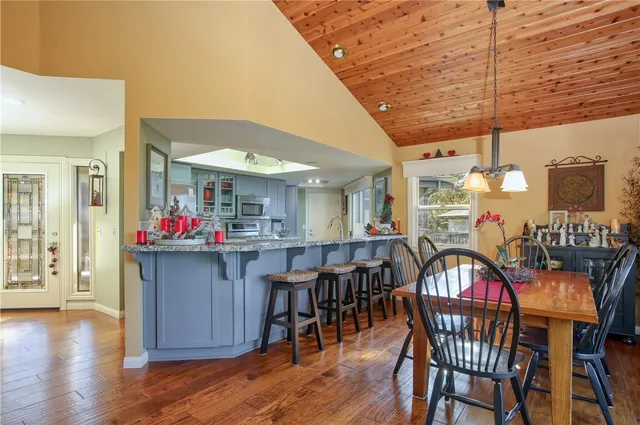 a dining room with furniture window and wooden floor