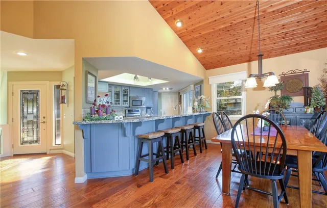 a dining room with furniture and wooden floor