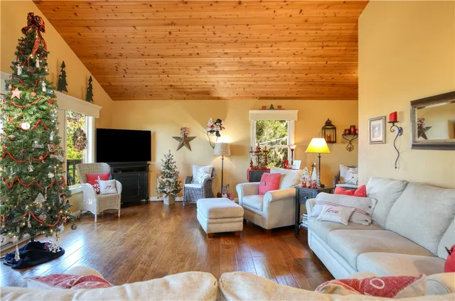 a living room with fireplace furniture and a large window