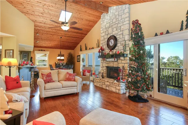 a living room with furniture a clock and a fireplace