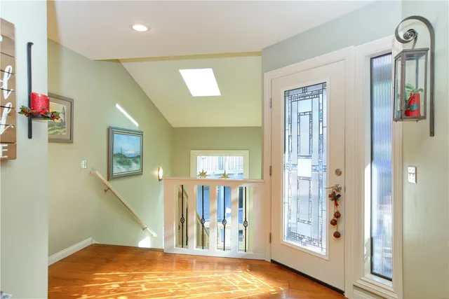 a view of a hallway with wooden floor and windows