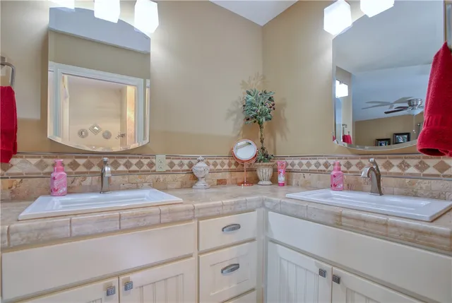 a bathroom with a double vanity sink and a mirror