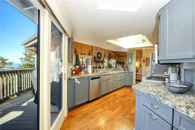a kitchen with stainless steel appliances granite countertop a stove and a sink
