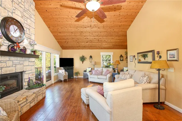 a living room with furniture a clock and a fireplace