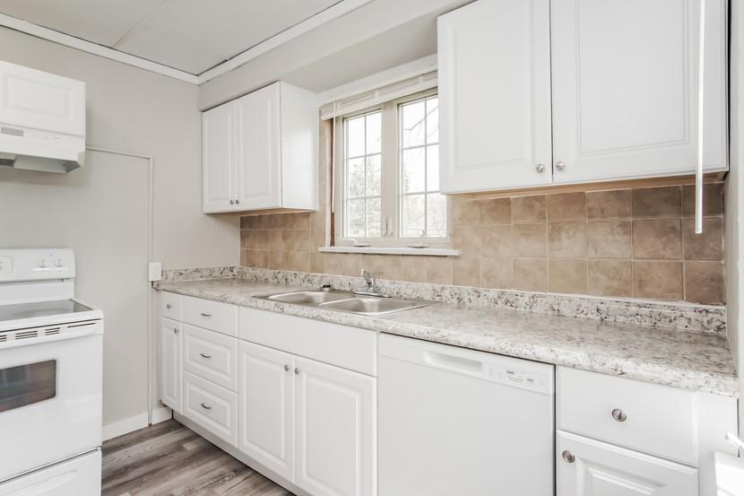 260 Ohio Street Monroeville, PA 15146 - Photo 4 of 13 a kitchen with granite countertop white cabinets and white appliances