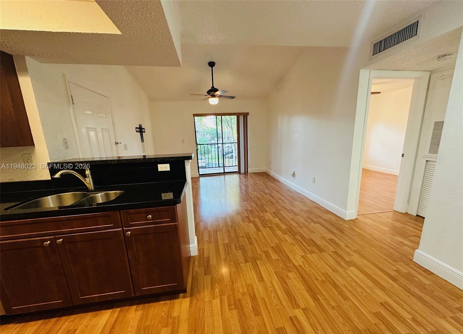 15680 Southwest 106th Lane, Unit 804 Miami, FL 33196 - Photo 13 of 32 a kitchen with a sink and wooden floor
