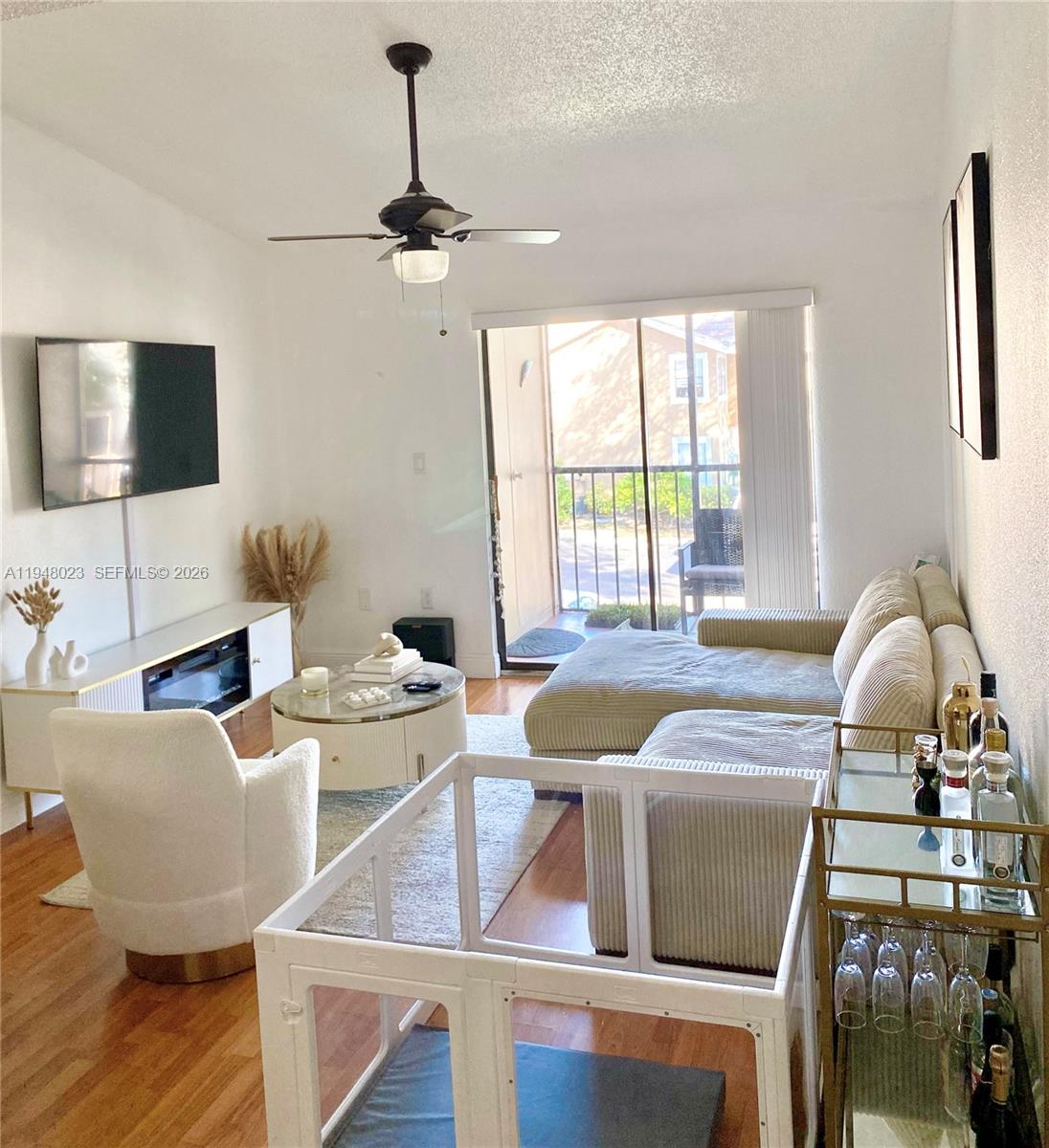 15680 Southwest 106th Lane, Unit 804 Miami, FL 33196 - Photo 15 of 32 a living room with furniture a flat screen tv and a window