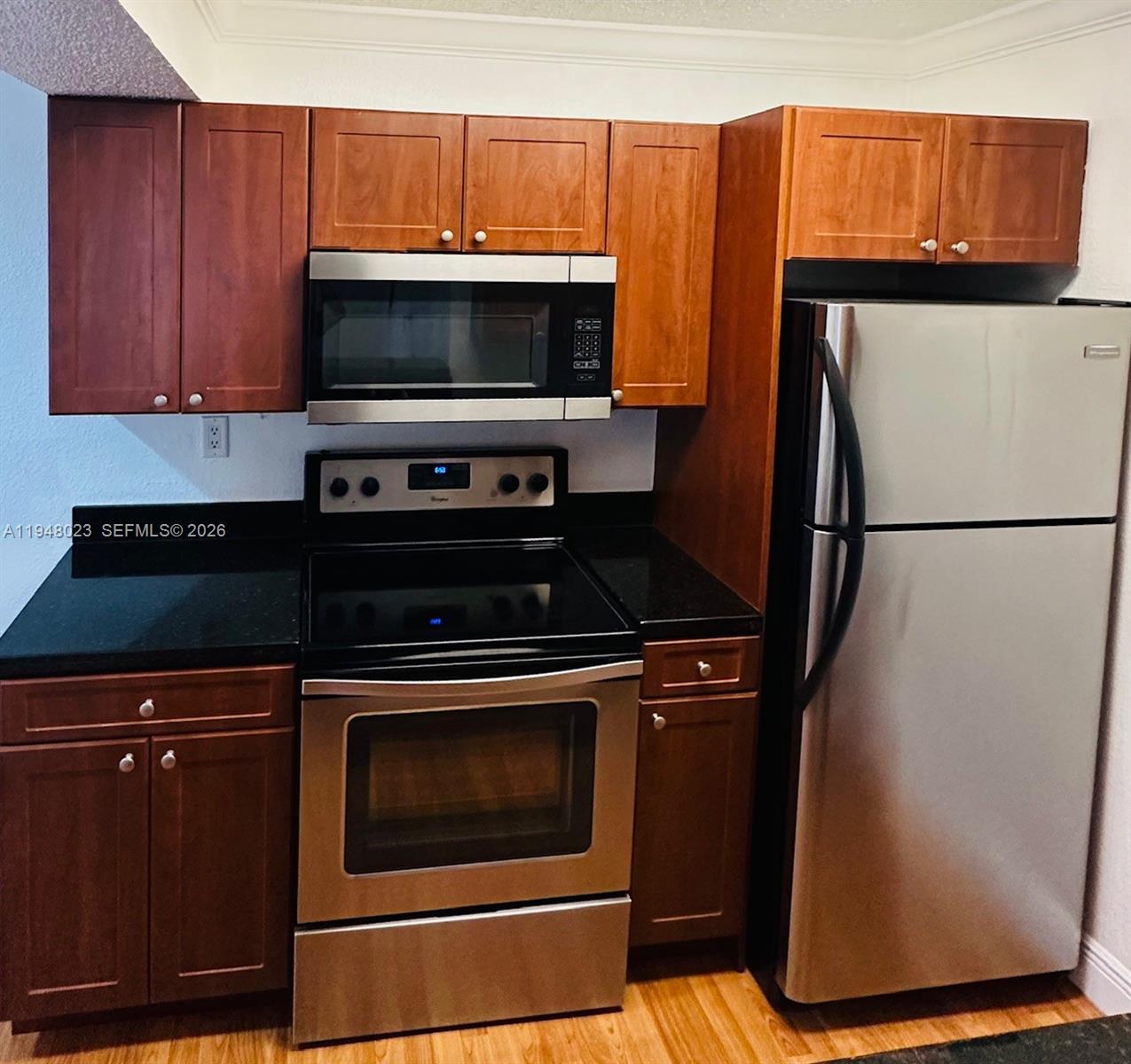 15680 Southwest 106th Lane, Unit 804 Miami, FL 33196 - Photo 18 of 32 a kitchen with a stove and a microwave