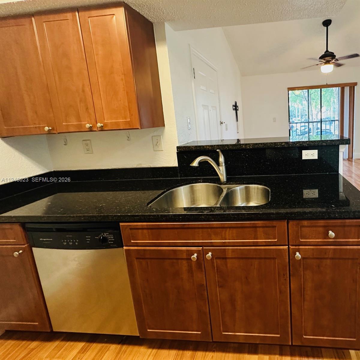 15680 Southwest 106th Lane, Unit 804 Miami, FL 33196 - Photo 19 of 32 a close view of a sink a microwave and cabinets