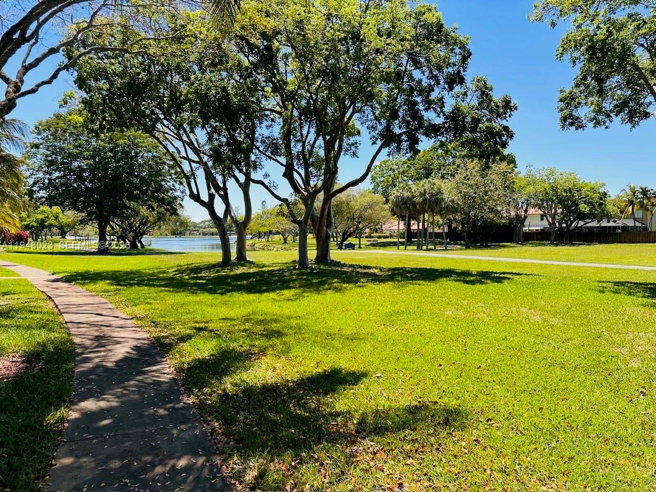 15680 Southwest 106th Lane, Unit 804 Miami, FL 33196 - Photo 27 of 32 a view of a swimming pool with an outdoor space and seating area