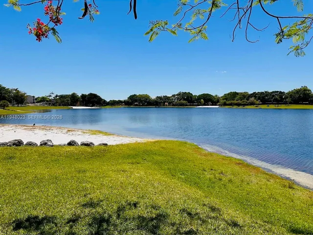 a view of a lake with houses in the background