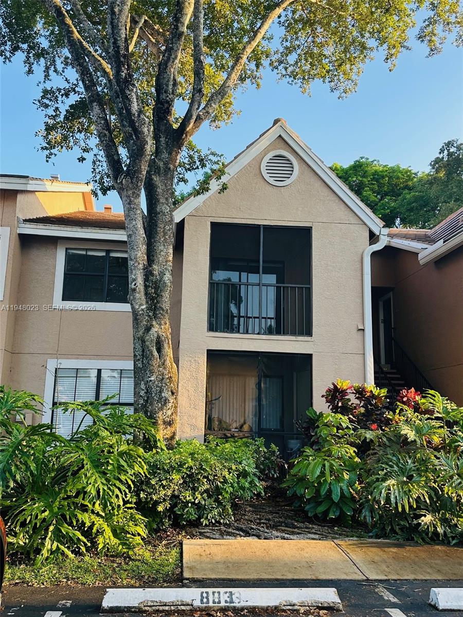 15680 Southwest 106th Lane, Unit 804 Miami, FL 33196 - Photo 10 of 32 a front view of a house with a yard and garage