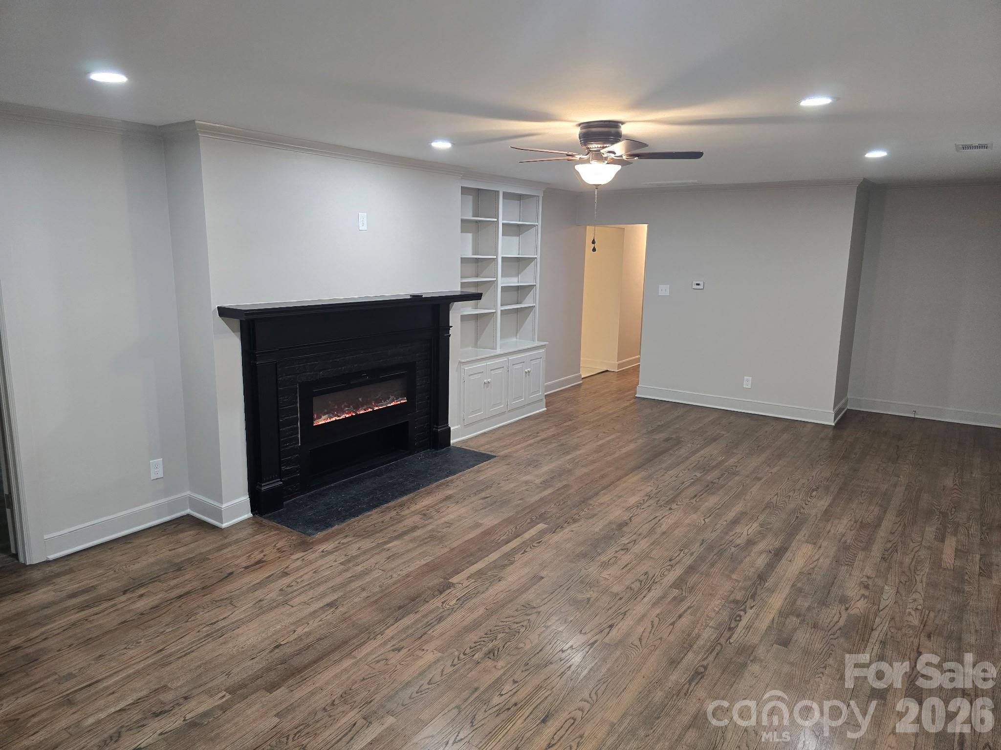 126 Sunset Drive Chester, SC 29706 - Photo 3 of 31 a view of an empty room with wooden floor fireplace and a window