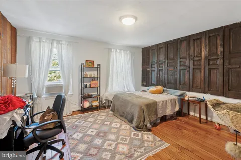 a bedroom with a bed and a chair