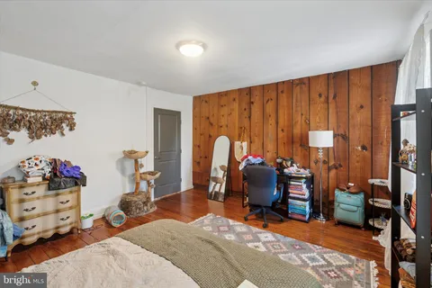 a bed room with a bed and a chair