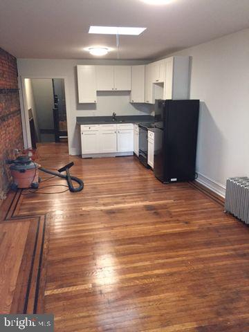 3816 Spring Garden Street Philadelphia, PA 19104 - Photo 26 of 30 a room with stainless steel appliances wooden floor and view living room