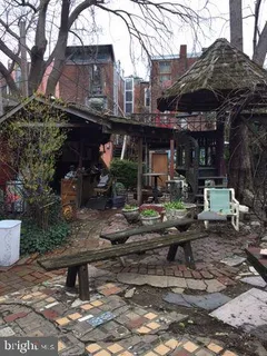 a view of a chairs and table in a backyard