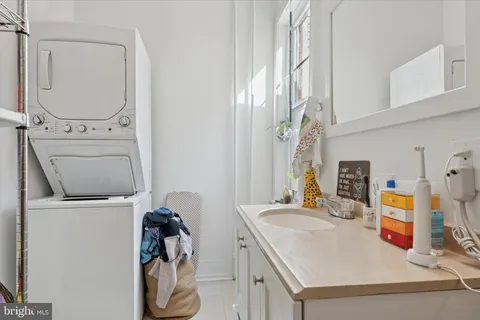 a bathroom with a sink a toilet and curtain