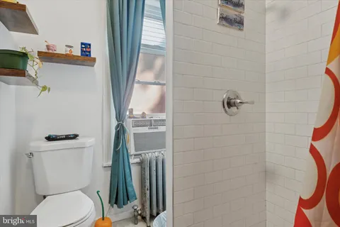 a white toilet sitting next to a bathroom sink