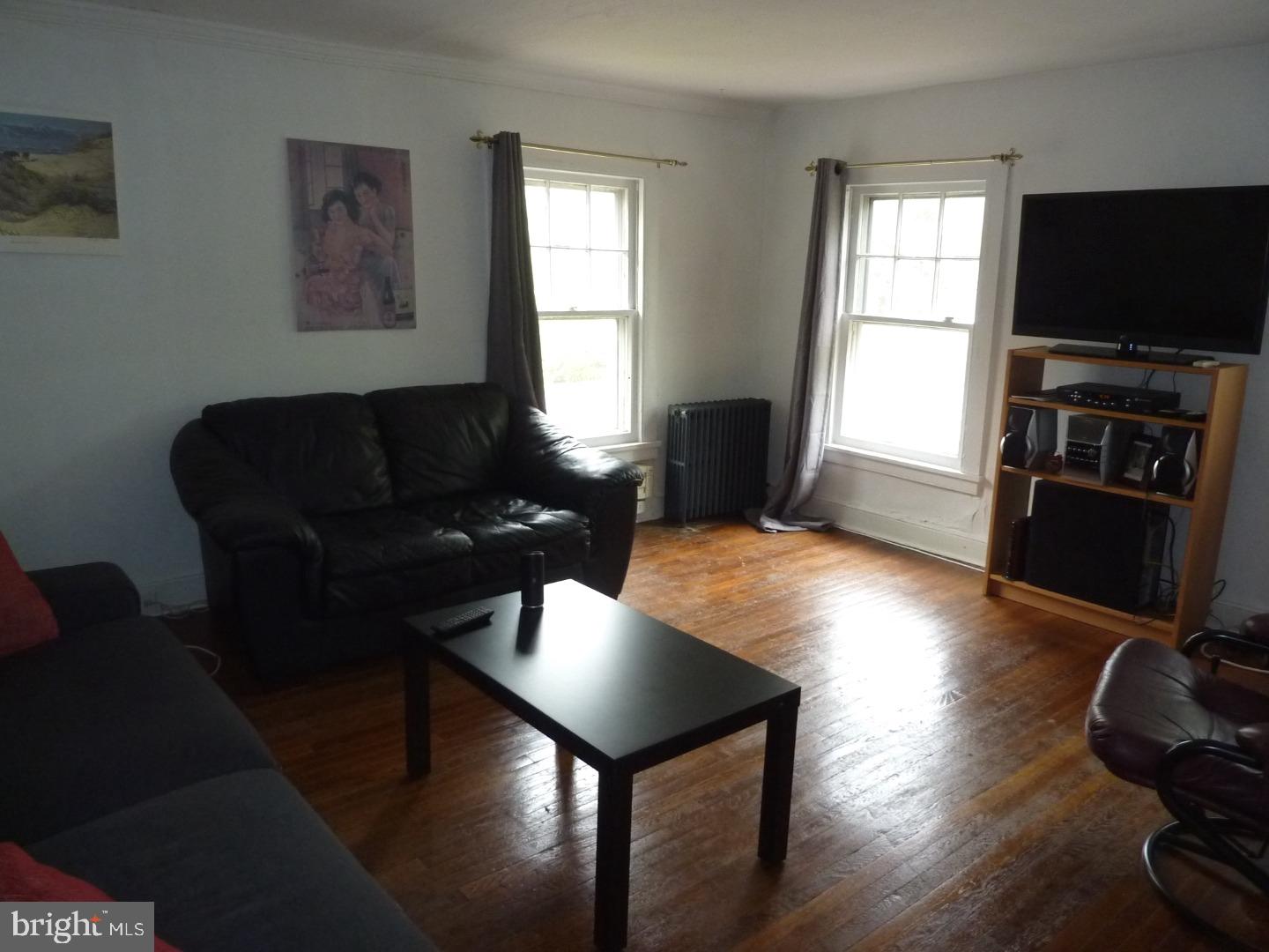 75 Patton Avenue, Unit 2 Princeton, NJ 08540 - Photo 2 of 6 a living room with furniture and a flat screen tv