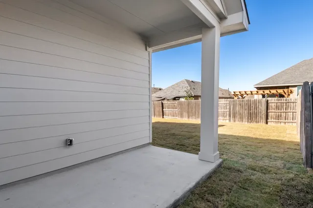 an empty room with windows and ceiling fan