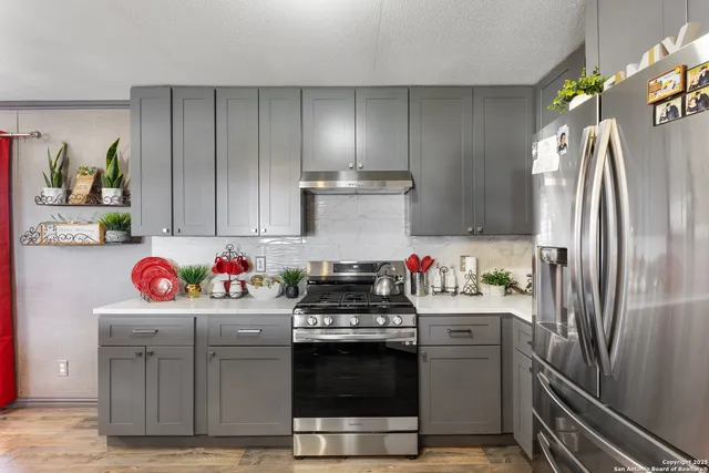 a kitchen with a stove and a refrigerator
