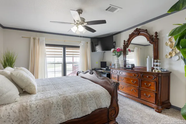 a bedroom with a large bed and a chandelier