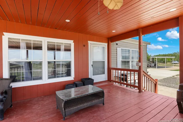 a view of a patio with couches and wooden floor
