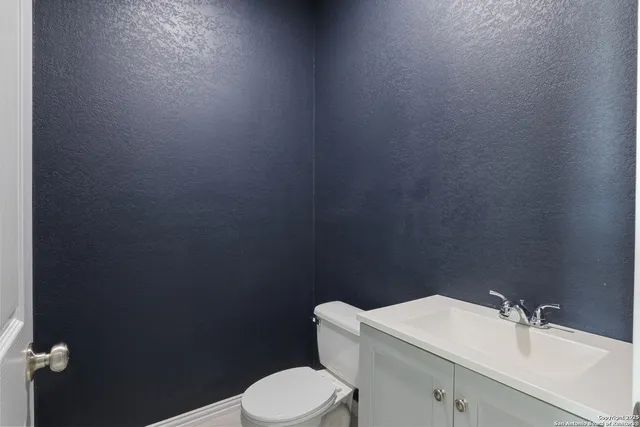 a bathroom with a sink toilet and mirror