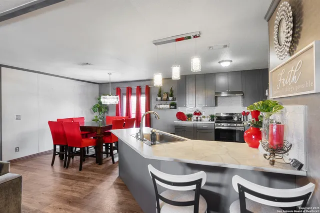 a view of a dining room with furniture and a chandelier