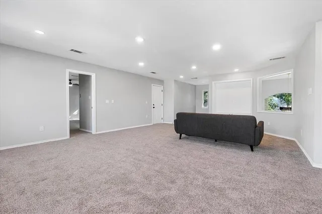 a living room with a couch and a window