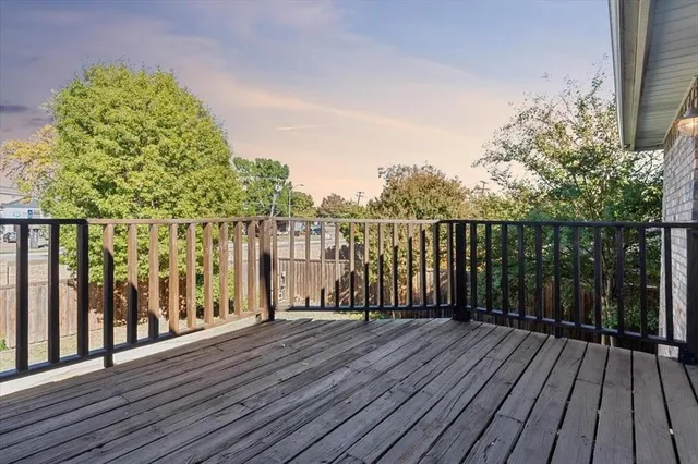 a view of a house with a small yard and wooden fence