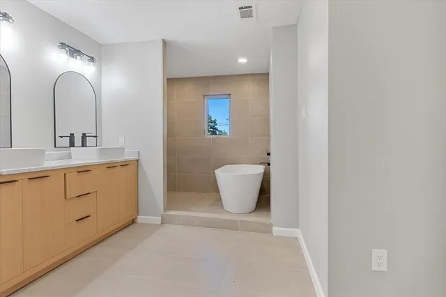 a bathroom with a double vanity sink and a mirror