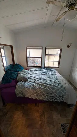 a bedroom with a bed window and dresser