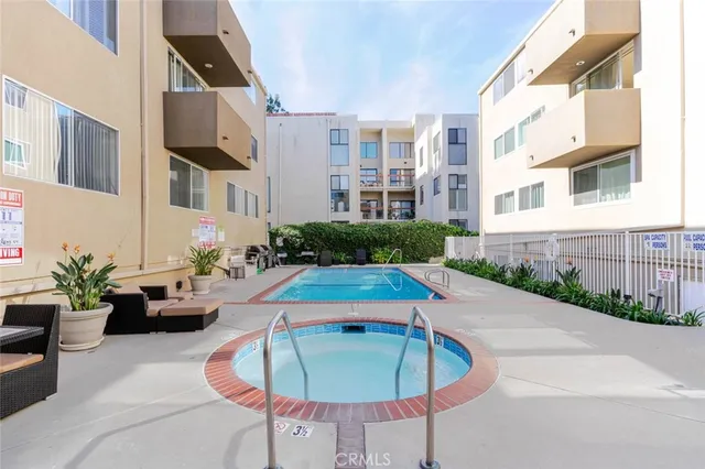 a view of a swimming pool with outdoor seating