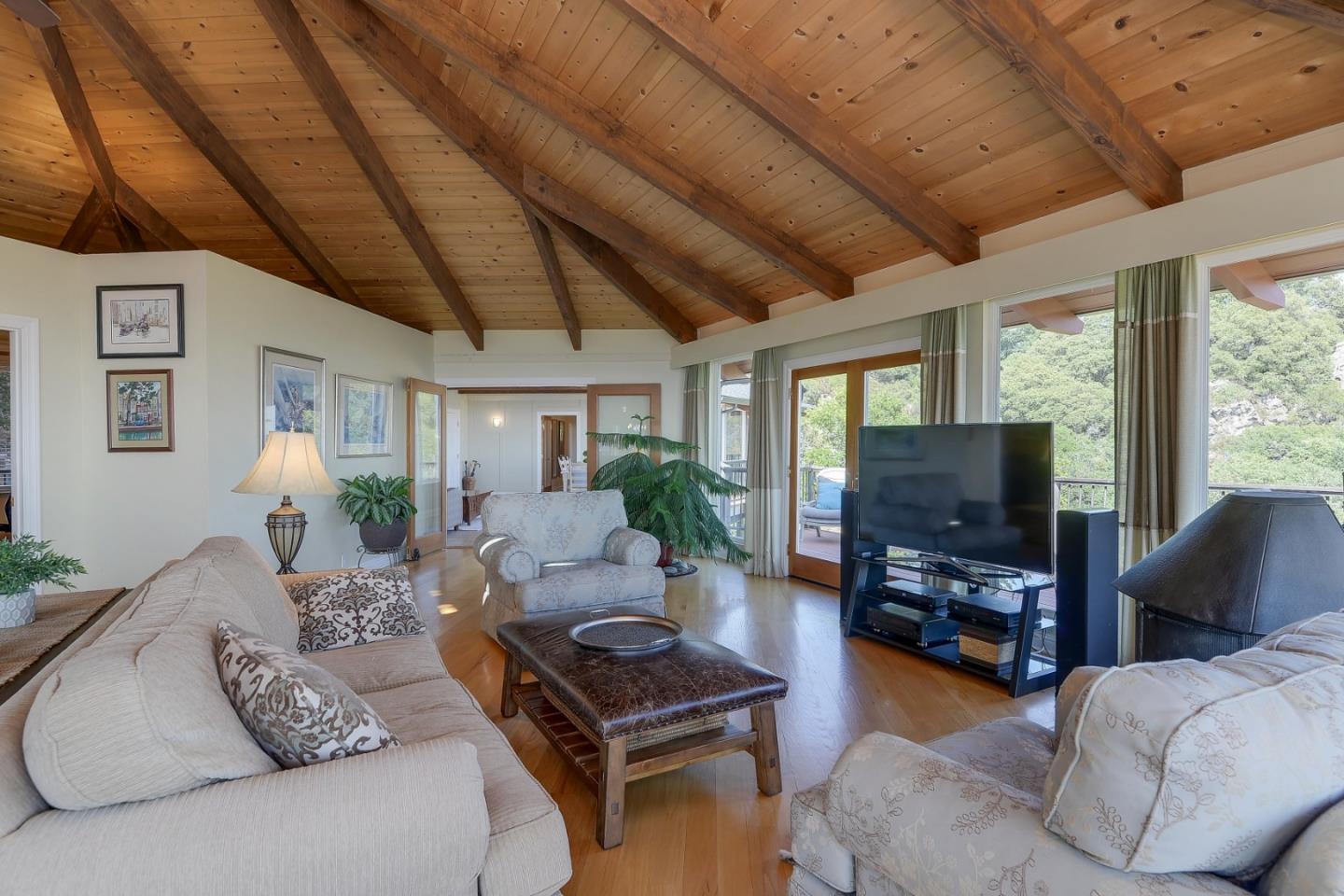 18503 Favre Ridge Road Los Gatos, CA 95033 - Photo 14 of 40 a living room with furniture a flat screen tv and a large window