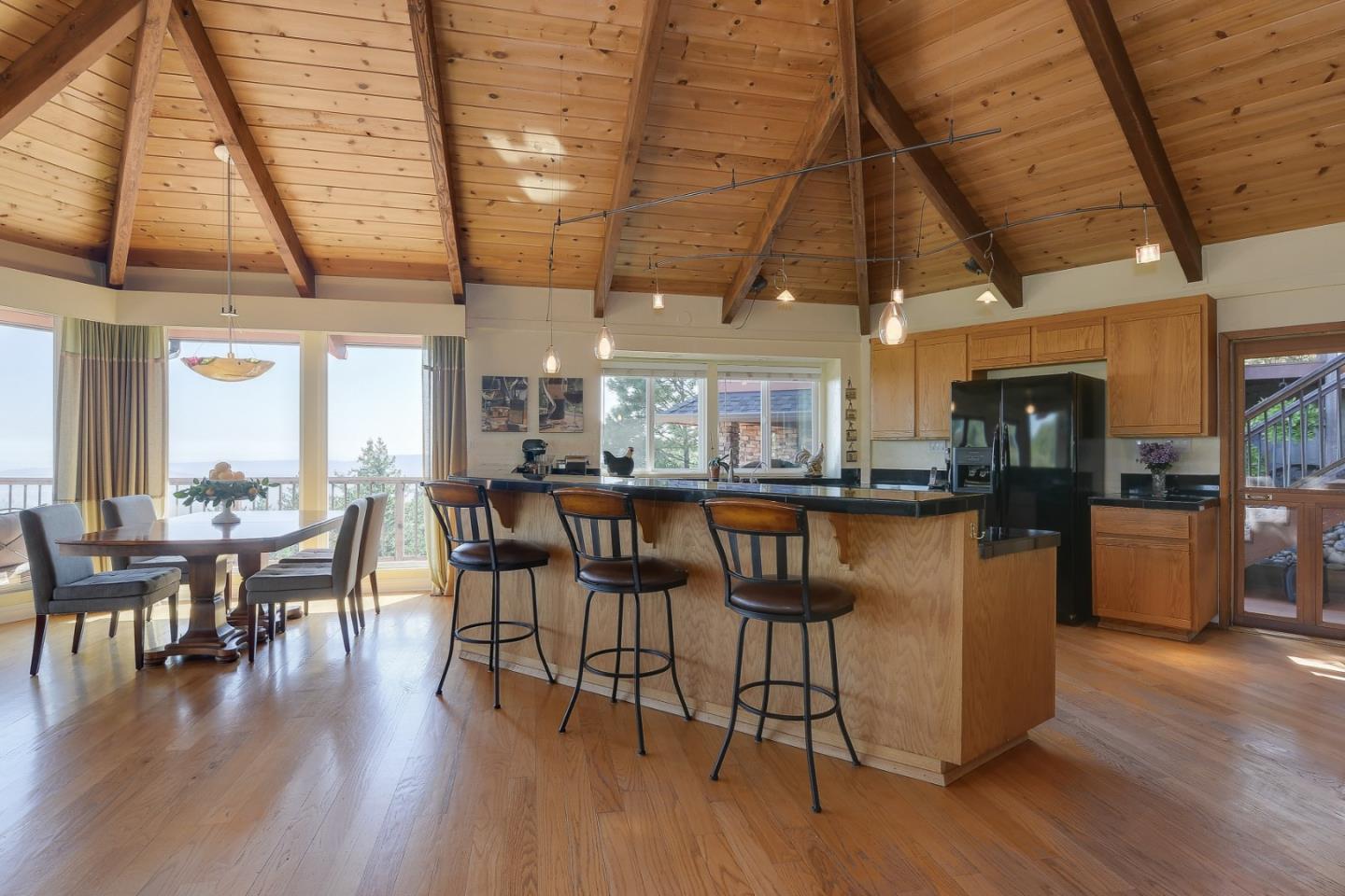 18503 Favre Ridge Road Los Gatos, CA 95033 - Photo 15 of 40 a dining room with stainless steel appliances granite countertop a table chairs and view of kitchen