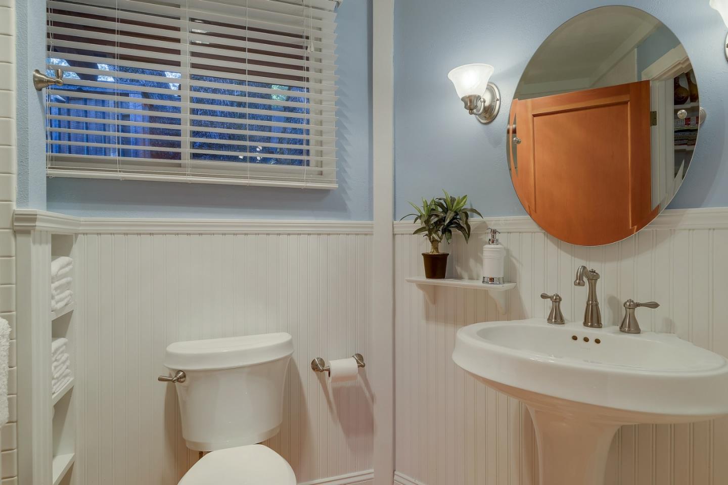 18503 Favre Ridge Road Los Gatos, CA 95033 - Photo 21 of 40 a bathroom with a toilet sink and mirror